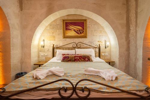 Ένα ή περισσότερα κρεβάτια σε δωμάτιο στο Nomads Cave Hotel & Rooftop