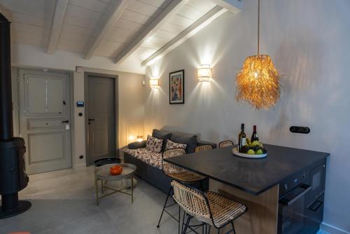 a living room with a couch and a table with wine bottles at Villa Hermes in Anafiotika Athens ! in Athens