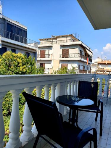 a balcony with a table and chairs on a balcony at Eantos Studios and Suites in Perea