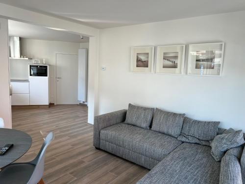 a living room with a couch and a table at De Haan App 1 in De Haan