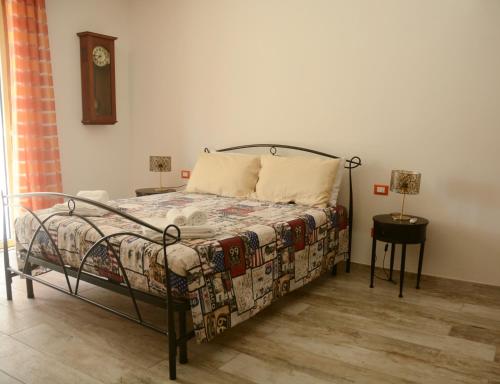 a bedroom with a bed and a clock on the wall at CivicoNove in Piombino