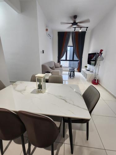 a living room with a white table and chairs at Horizon Premium Suite - Ipoh in Ipoh