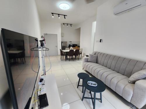 a living room with a couch and a tv at Horizon Premium Suite - Ipoh in Ipoh