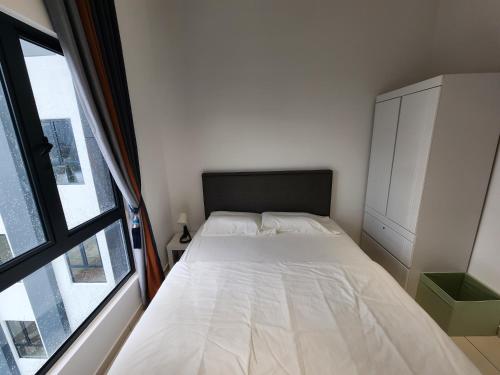 a small bedroom with a bed and a window at Horizon Premium Suite - Ipoh in Ipoh