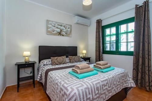 a bedroom with a bed with two pillows on it at Casa Luna in Puerto del Carmen