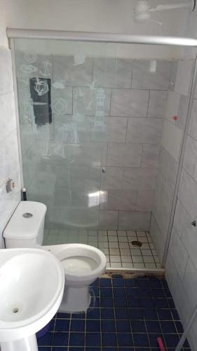 a bathroom with a toilet and a sink at apartamento itapua in Salvador