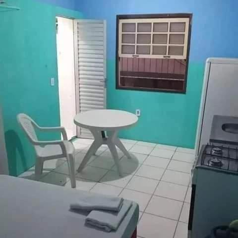 a kitchen with a table and a table and a chair at apartamento itapua in Salvador