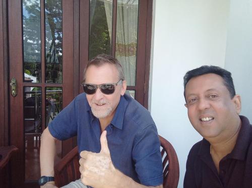 two men giving a thumbs up while sitting at Vino Villa Tourists & Local Accommodations - 24 Hrs in Kandy