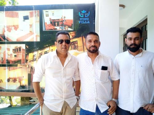 three men are standing next to each other at Vino Villa Tourists & Local Accommodations - 24 Hrs in Kandy
