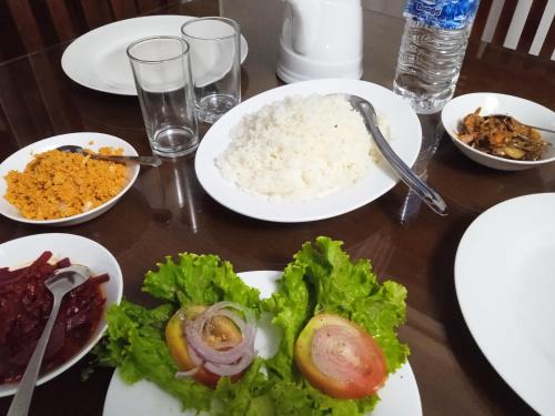 a table with plates of food and rice on it at Vino Villa Tourists & Local Accommodations - 24 Hrs in Kandy