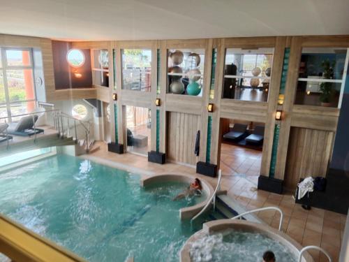 a swimming pool with a person in a tub at Camping siblu vue sur Canigou in Canet-en-Roussillon