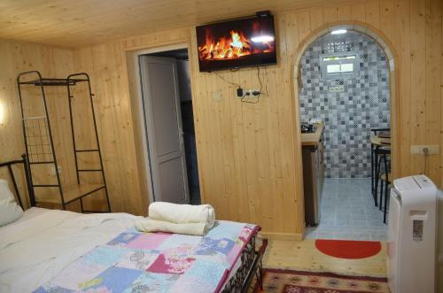 a bedroom with a bed and a fireplace in it at Terrace Center in Kutaisi