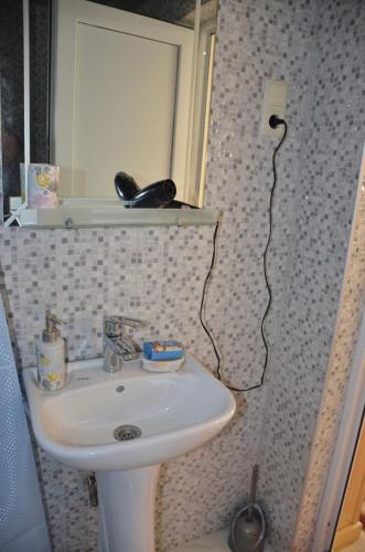 a bathroom with a sink and a mirror at Terrace Center in Kutaisi