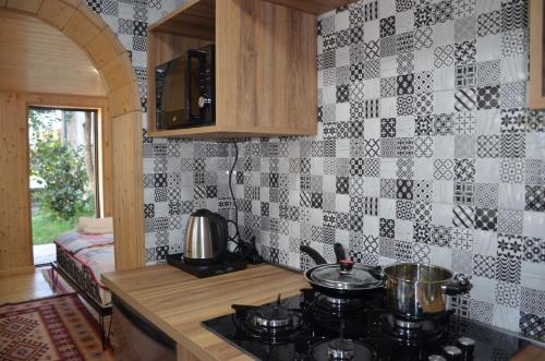 a kitchen with a stove with pots and pans on it at Terrace Center in Kutaisi