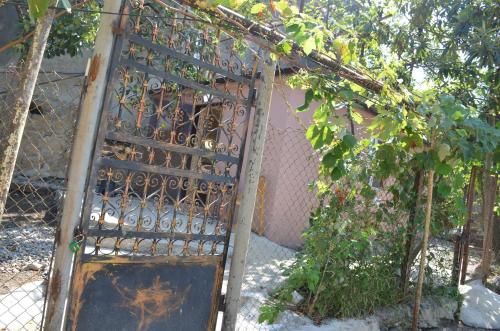 an old gate in front of a fence at Terrace Center in Kutaisi
