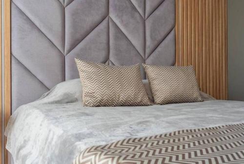 a bed with two pillows on top of it at Apartament Harmony in Sunny Beach