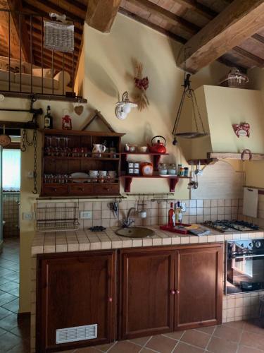 a kitchen with wooden cabinets and a sink and a stove at Il Forcone in Panicale