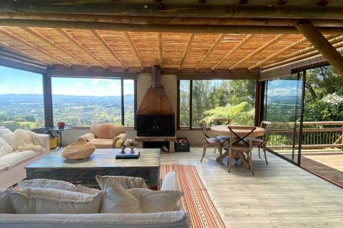 a living room with a fireplace and a table at LAS NUBES - Donde la energía fluye, el alma se cura in Rionegro