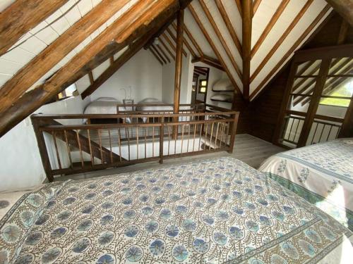 an attic bedroom with a bed and a balcony at LAS NUBES - Donde la energía fluye, el alma se cura in Rionegro