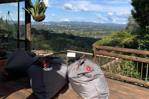 two sleeping bags sitting on a deck with a view at LAS NUBES - Donde la energía fluye, el alma se cura in Rionegro