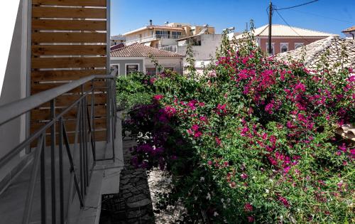 a balcony with pink flowers on the side of a building at SEITAN PAZAR (Olive/Akrokeramos) in Preveza