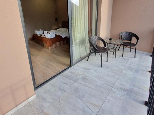 a room with chairs and a table and a bed at Hotel Sweet Night in Stepantsminda