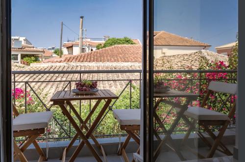 a balcony with a table and chairs on a balcony at SEITAN PAZAR (Olive/Akrokeramos) in Preveza