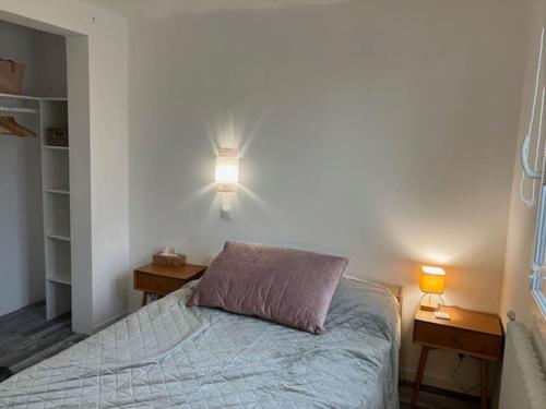 a bedroom with a bed with two nightstands and two lamps at Maison avec jardin à Laon / House with Garden in Laon in Laon