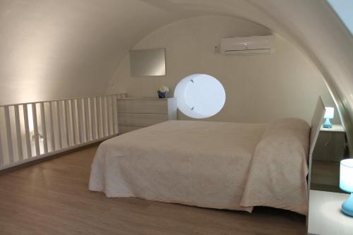 ein Schlafzimmer mit einem Bett in einem weißen Zimmer in der Unterkunft Casetta Pisanelli 25 in Mottola