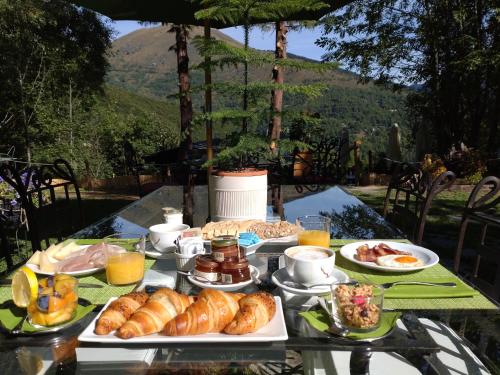 a table topped with plates of pastries and breakfast foods at Chalet BRAGARD in Limone Piemonte