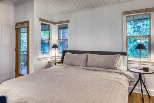 a white bedroom with a large bed with windows at Inviting Tahoe Escape in Incline Village