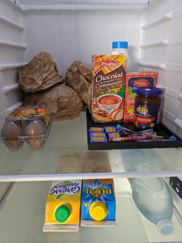 a refrigerator filled with food and snacks in it at Villa Stone pour 8 personnes, piscine chauffée 5 euros par jour, accès PMR, 5 étoiles in Sainte-Luce