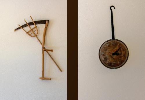 a clock hanging on a wall next to a door at Chalet Bargsunna in Wengen