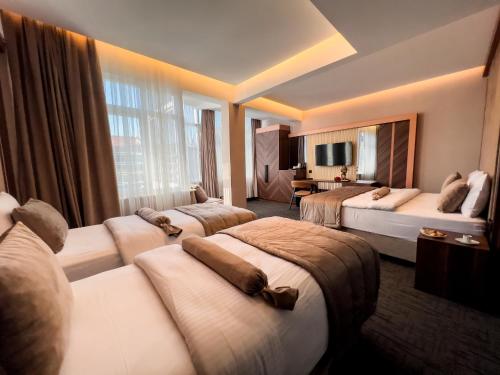 a hotel room with four beds and a television at THE PARK HOTEL in Istanbul