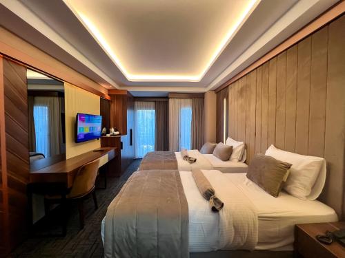 a hotel room with two beds and a television at THE PARK HOTEL in Istanbul