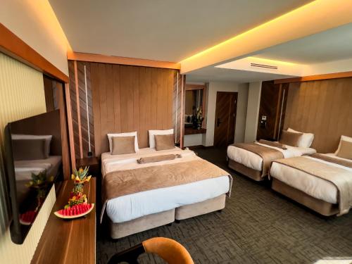 a hotel room with two beds and a table at THE PARK HOTEL in Istanbul