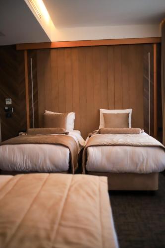 two beds in a room with a wall at THE PARK HOTEL in Istanbul