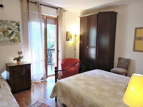 a bedroom with a bed and a chair and a window at Freetime in Perugia