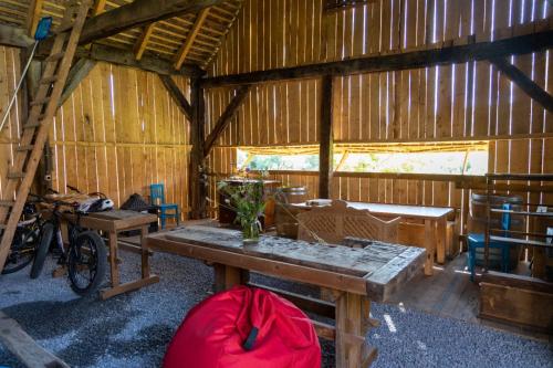 a room with a table and chairs in a barn at Critz Cross in Criţ