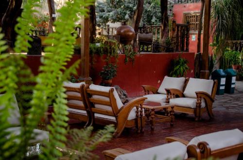 a group of chairs and tables in a courtyard at Hotel & Hacienda El Carmelo in Ica