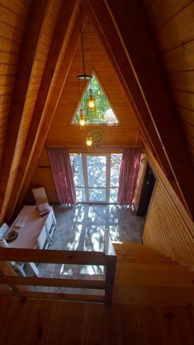 an attic room with a large window and a chandelier at Sionis Idilia in Sioni