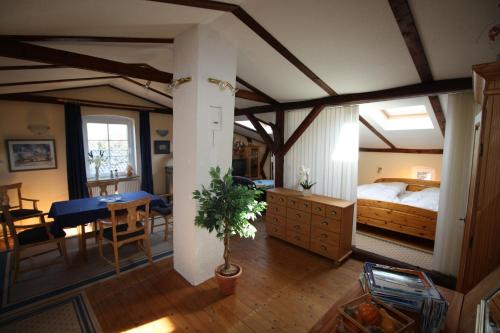 a bedroom with a large bed and a dining room at Landhaus Questin in Alt Bukow