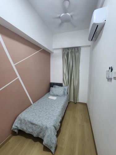 a small bedroom with a bed and a ceiling fan at Praicon Tower - Premium Suite in Butterworth