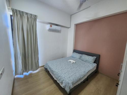 a bedroom with a bed with a stuffed animal on it at Praicon Tower - Premium Suite in Butterworth