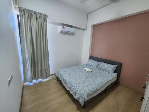 a small bedroom with a bed and a window at Praicon Tower - Premium Suite in Butterworth