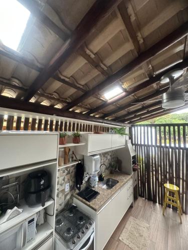 a kitchen with a stove top oven in a trailer at Village ITACIMIRIM SUMMER HOUSE in Camaçari