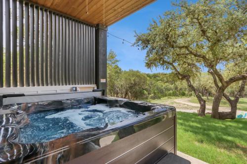 a hot tub in the backyard of a house at Canary Lakehouse in Canyon Lake