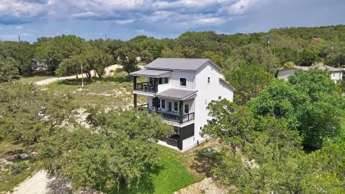 an aerial view of a house on a hill with trees at Canary Lakehouse in Canyon Lake
