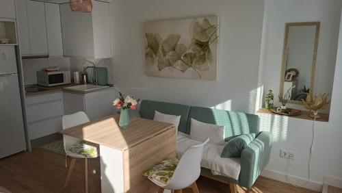 a living room with a couch and a table at La casita de los mandalas in Cazorla
