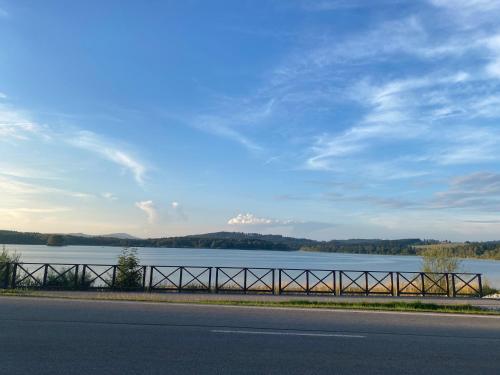 a road with a view of a body of water at Apartmán Na Břehu Lipna in Černá v Pošumaví